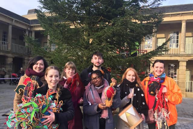 Students from Manchester Metropolitan University posing with their handmade decorations at the Piece Hall.