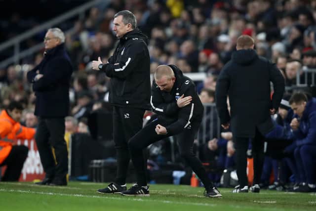 LONDON, ENGLAND - JANUARY 06:  Pete Wild, Manager of Oldham Athletic and his backroom staff celebrates at the final whistle during the FA Cup Third Round match between Fulham and Oldham Athletic at Craven Cottage on January 6, 2019 in London, United Kingdom.  (Photo by Julian Finney/Getty Images)