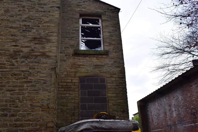 The building, believed to be the home of the fire, has all its windows smashed in