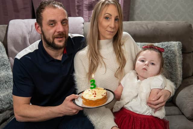 Little Kia Gott celebrates her third birthday with her family., Pictured with parents Vikki and Paul at home (Pictures SWNS)