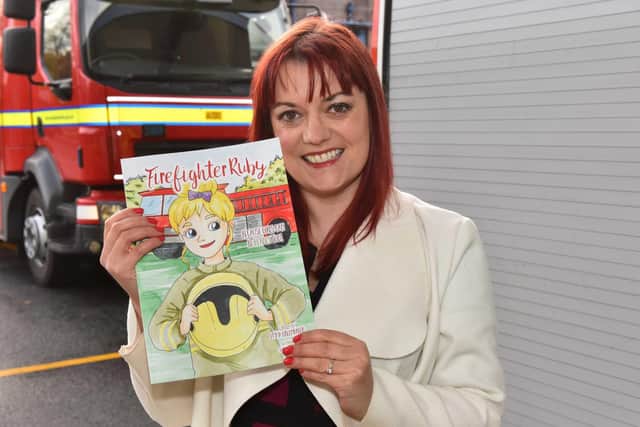 West Yorkshire Fire and Rescue Services Communications Manager, Emma Greenhalgh, with her new book Firefighter Ruby