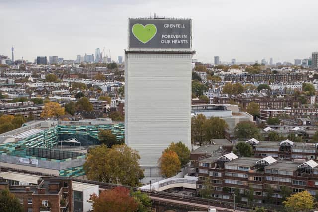A general view of what remains of Grenfell Tower covered with hoardings following a severe fire in June 2017 . (Photo by Dan Kitwood/Getty Images)