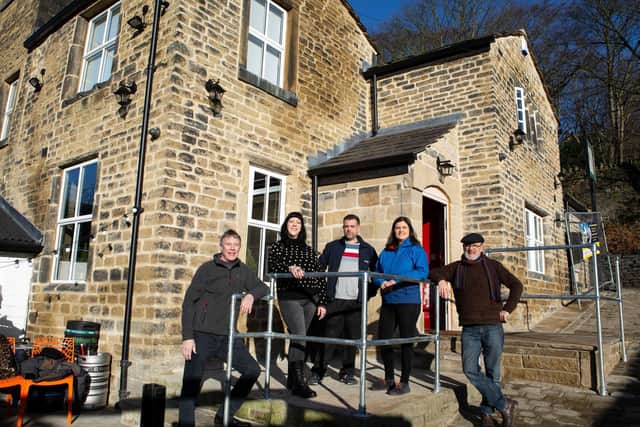 Committee members, Paul Mansley - chair, Jenny Bromley, Sam Irvine, Netty Berry and Bruce Fitzgerald celebrating the the Puzzle Hall Inn, now a community pub, has opened again, on Hollins Mill Lane, Sowerby Bridge