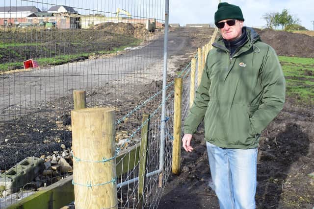 Brian Crossley of Shelf and Northowram Local Plan Forum stood at the site next to the newly-installed barbwire fence