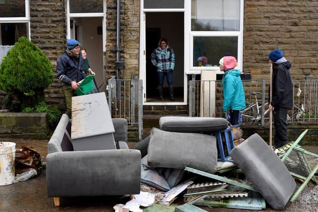 Residents begin clearing up following severe flooding. (Photo by Anthony Devlin/Getty Images)