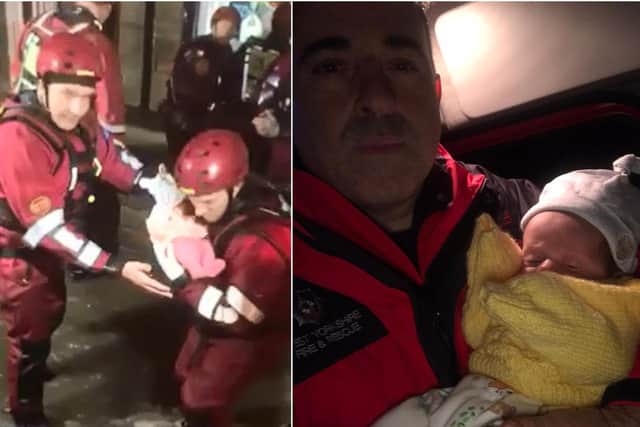 Firefighters rescue a one-year-old and seven-week-old twins from a flooded house in Elland (Picture West Yorkshire Fire and Rescue Service)