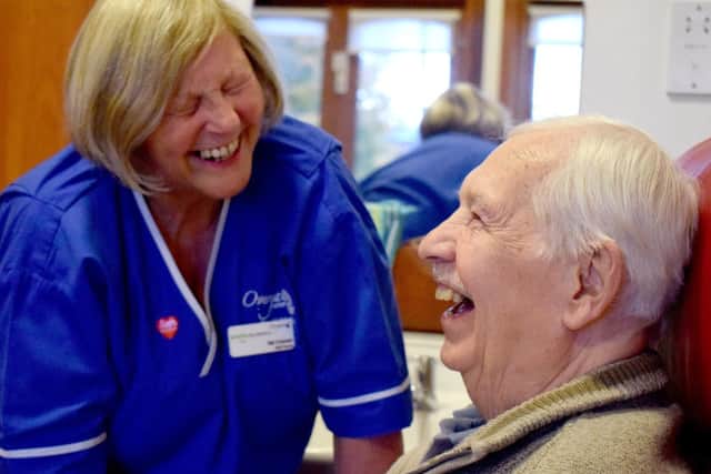 Nurse Val Craven laughing with a patient.