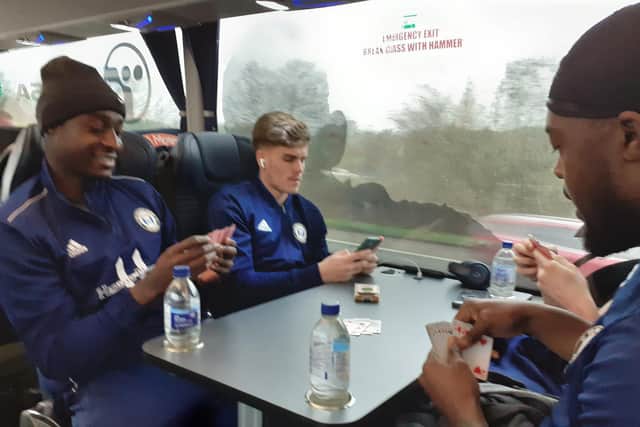 FC Halifax Town players enjoy a card game on the journey down to Torquay