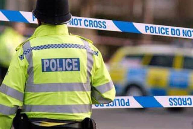Detectives in Calderdale are hunting two men after an armed robbery in Brighouse
