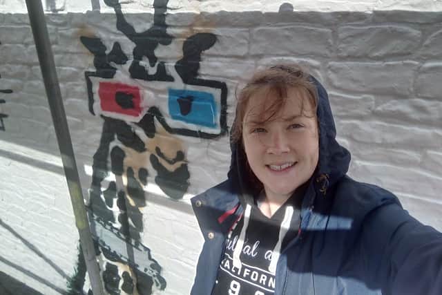 London artist Anna Jaxe with her mural. Picture: BBC.