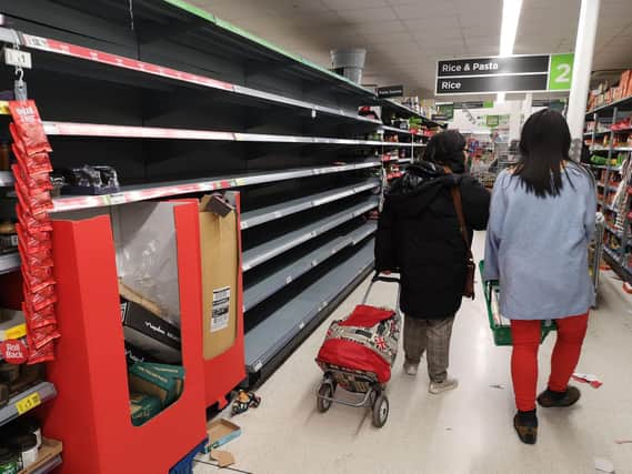 Consumers shop in near empty aisles of a supermarket in London. (Photo by JUSTIN TALLIS/AFP via Getty Images)