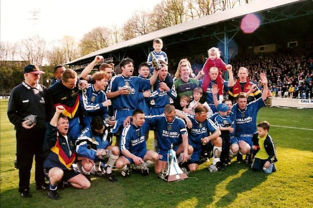 The promotion-winning side from the 1997-98 season celebrate with the trophy. Photo: Johnny Meynell