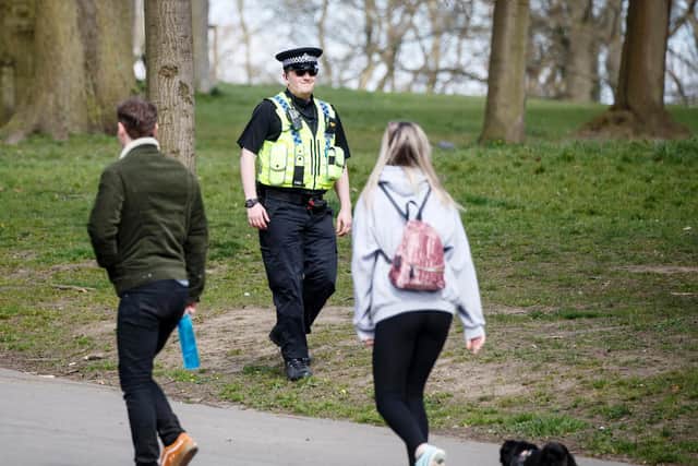 A policeman walks past people exercising with a dog in Roundhay Park, Leeds, as the UK continues in lockdown to help curb the spread of the coronavirus. Picture: Danny Lawson/PA