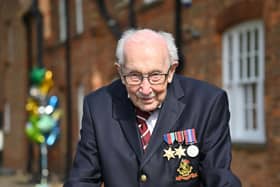 British World War II veteran Captain Tom Moore, 99, poses doing a lap of his garden in the village of Marston Moretaine, 50 miles north of London, on April 16, 2020. - A 99-year-old British World War II veteran Captain Tom Moore on April 16 completed 100 laps of his garden in a fundraising challenge for healthcare staff that has "captured the heart of the nation", raising more than £13 million ($16.2 million, 14.9 million euros). "Incredible and now words fail me," Captain Moore said, after finishing the laps of his 25-metre (82-foot) garden with his walking frame. (Photo by JUSTIN TALLIS / AFP) (Photo by JUSTIN TALLIS/AFP via Getty Images)