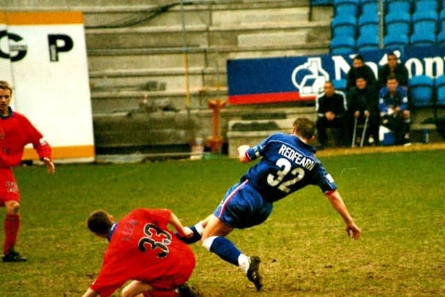 Redfearn tackles Macclesfield's Kevin Keen at The Shay. Photo: Johnny Meynell