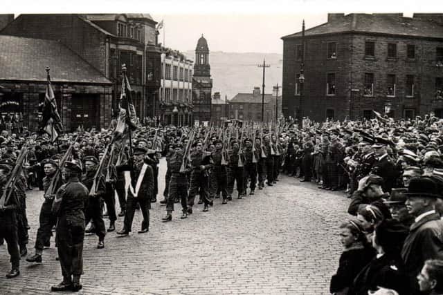 Crowds watch The Dukes marching into Bull Green, Halifax, after the Freedom of the Borough ceremony in June 1945