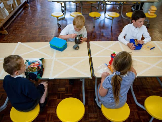 Children of essential workers eat lunch in segregated positions at Kempsey Primary School in Worcester.  Picture: Jacob King/PA