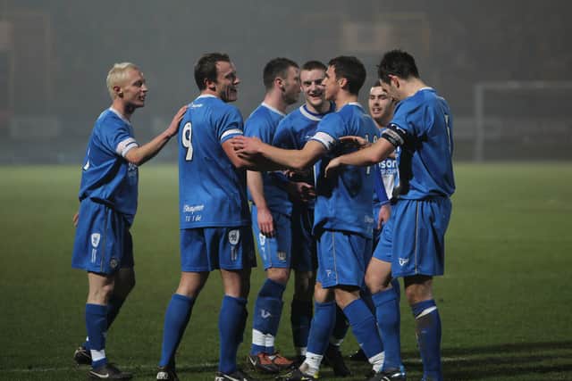 Bower (right) joins the celebrations after a Danny Holland goal at home to Stocksbridge