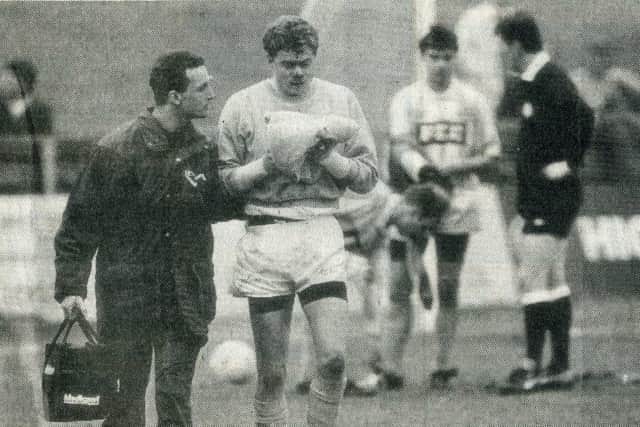 Jonathan Gould leaves the field having been injured against Walsall in March 1991, with Tommy Graham getting prepared to take over in goal. Photo: Johnny Meynell