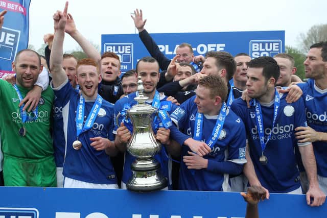 Halifax players, with Glennon (far left) celebrate the play-off victory at Brackley in 2013