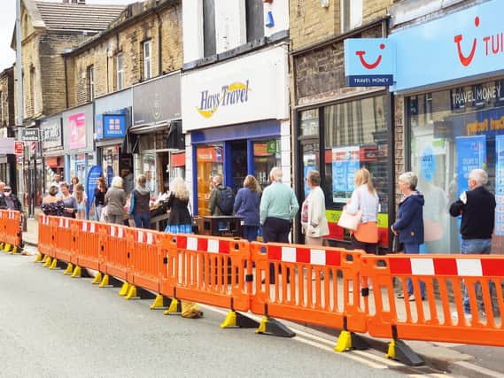 Queues of socially distanced shoppers as Brighouse businesses re-open. Picture: Steven Lord.