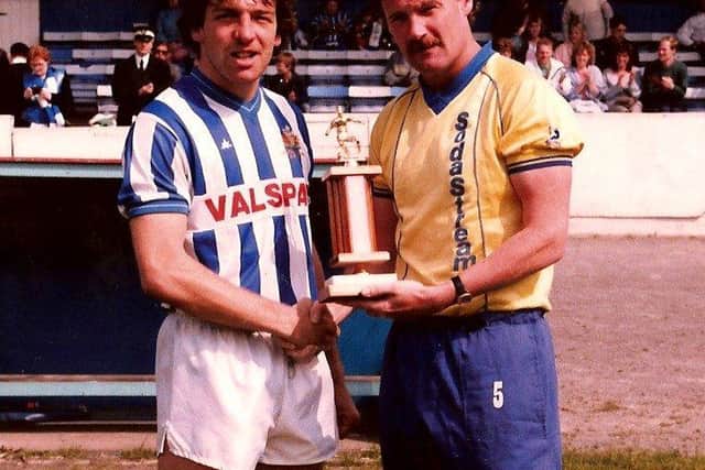 Holden receives the player of the year trophy for the 1986-87 season. Photo courtesy of Johnny Meynell