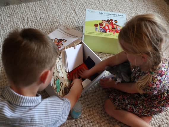 The boxes are filled with a range of activities aimed at prompting memories.