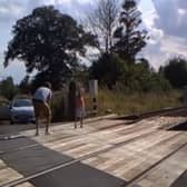Shocking CCTV footage has been released which shows people risking their lives on level crossings - including a father and his young daughter posing for a photo shoot.