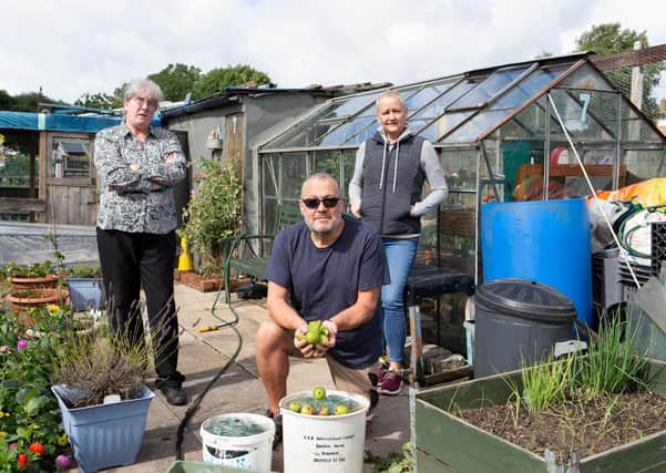 Diana Rice, Ian Webster and Liz Webster, at Waterloo Road Allotments, Brighouse, with buckets of broken glass after vandals have smashed windows of their greenhouses