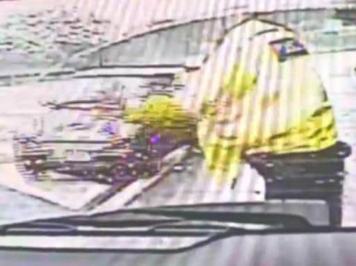 Driver swerves out of the closed M62 lane and gestures at police officer