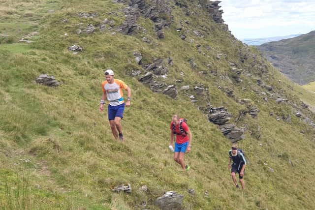 Math Roberts, the new Paddy Buckley record holder, with members of his support team Andrew Schofield from Borrowdale FR and Gavin Roberts from Eryri Harriers.