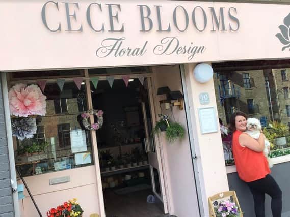 Cece Cashman with her dog Millie outside CeCe Blooms in Sowerby Bridge.