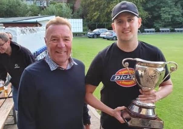 Tim Helliwell, Halifax Cricket League secretary, presents Adam Stocks of Triangle with the Prermier Division First XI trophy