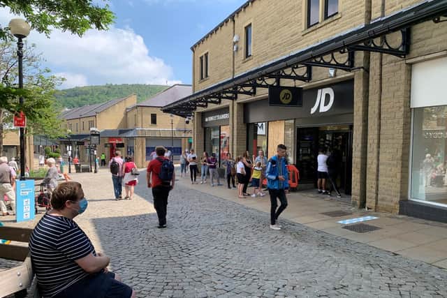 Queues outside shops due to social distancing have become a regular site across Calderdale