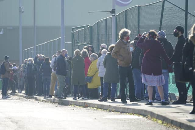 Members of the public queue at a mass Covid-19 testing site in Liverpool (Photo by Christopher Furlong/Getty Images)
