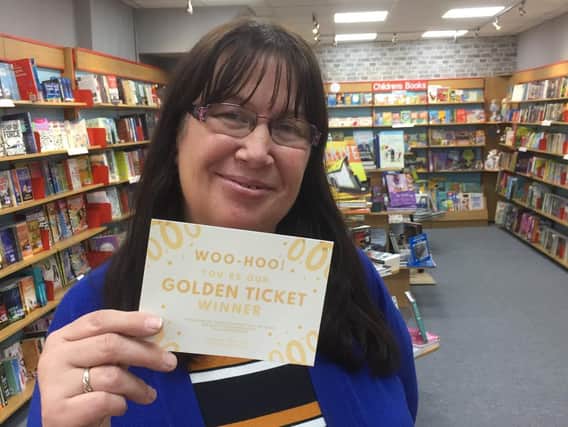 Anne Colley with one of the Golden Tickets at Brighouse Books.