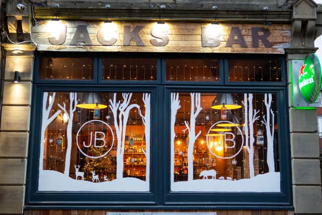 A Level art student Abby Gledhill, has painted the windows of Jack's Bar, Elland, to help brighten up the town