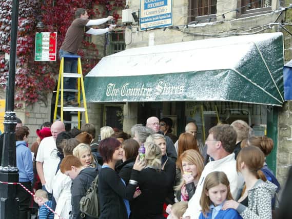 Crowds gather to watch the Christmas advert being filmed in Hebden Bridge in 2009.