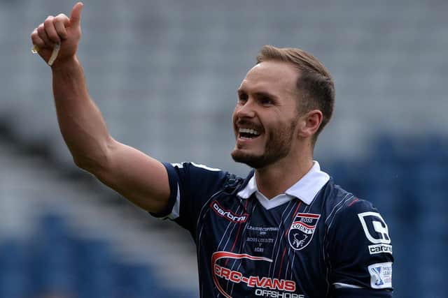Martin Woods celebrates winning the League Cup as Ross County beet Hibernian 2-1 during the Scottish League Cup Final at Hampden Park on March 13, 2016. (Photo by Mark Runnacles/Getty Images)