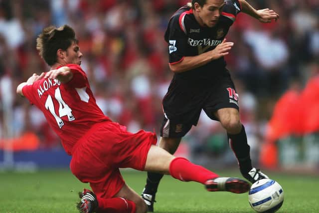 Martin Woods avoids a challenge from Xabi Alonso during the match between Liverpool and Sunderland at Anfield on August 20, 2005.  (Photo by Shaun Botterill/Getty Images)