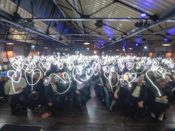 Last years audience of the Calderdale Community Spirit Awards created hears made with the light on their mobile phones
