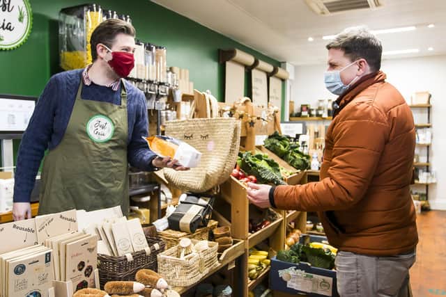 Ross Denby, left at Just Gaia, plastic-free shop in The Piece Hall, Halifax, with customer Dave Roy.