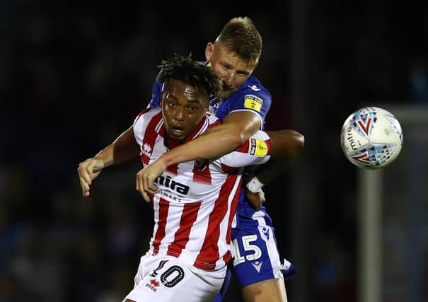 BRISTOL, ENGLAND - AUGUST 13:  Alfie Kilgour of Bristol Rovers challenges Tahvon Campbell of Cheltenham Town during the Carabao Cup First Round match between Bristol Rovers and Cheltenham Town at Memorial Stadium on August 13, 2019 in Bristol, England. (Photo by Michael Steele/Getty Images)