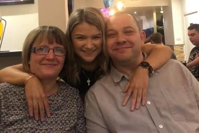 Aimee Flannery, 18, pictured, centre, with her mum Michelle and dad Gary, took part in a walking challenge of 10,000 steps a day for 120 days for the Stroke Association