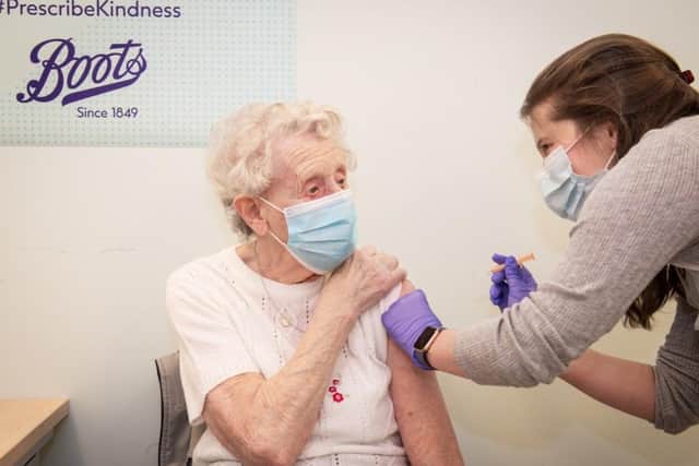 Brenda Clegg receiving her vaccination at Boots in Halifax