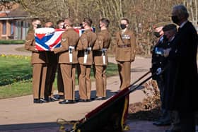 BEDFORD, ENGLAND - FEBRUARY 27: (No reuse after 11.59pm on March 6th 2021 without written consent from gemma@captaintom.org.) The coffin of Captain Sir Tom Moore is carried by members of the Armed Forces during his funeral at Bedford Crematorium on February 27, 2021 in Bedford, England. WWII veteran, Sir Tom raised nearly £33 million for NHS charities ahead of his 100th birthday last year by walking laps of his garden in Marston Moretaine, Bedfordshire. He died on the 2nd of February after testing positive for COVID-19. (Photo by Joe Giddens - Pool/Getty Images)