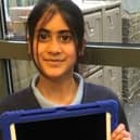 School student holding one of the newly gifted ipads funded by Rotary.