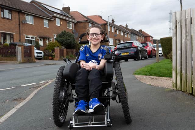 Halifax Town fan Charlie, with his new wheelchair, bought with funds raised after an appeal