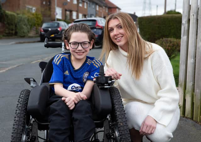 Halifax Town fan Charlie, with his mum Lucy Littley and the new wheelchair, bought with funds raised after an appeal