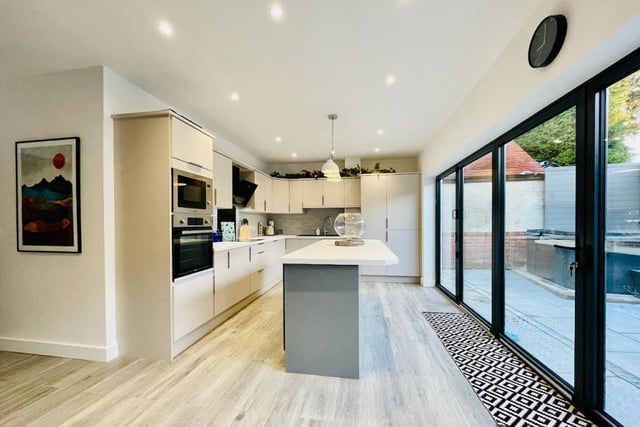 The most stunning aspect of the house at the rear is the open plan living kitchen with bi-folding doors leading out to the rear patio with hot tub.